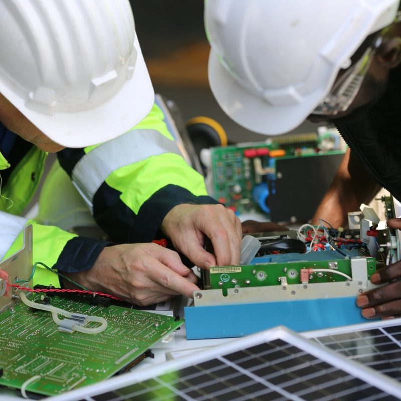 Workers assemble energy system with solar panel for electricity Workers assemble energy system with solar panel for electricity